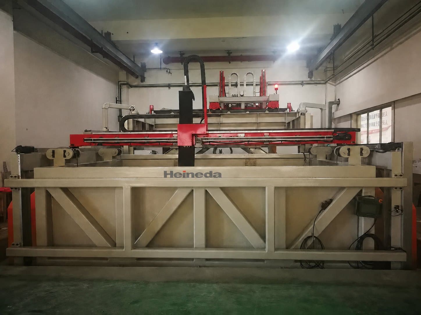 Submerged ultrasonic scanning gantry over a plated immersion tank.